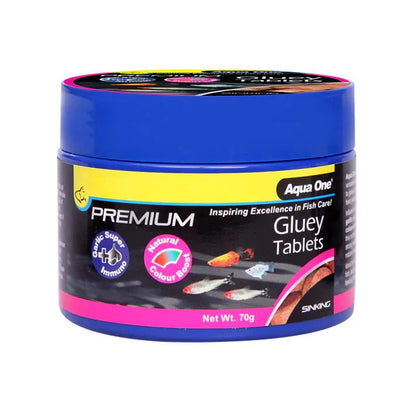 AquaMunch Premium Gluey Tablets attached to aquarium glass for feeding fish and shrimp